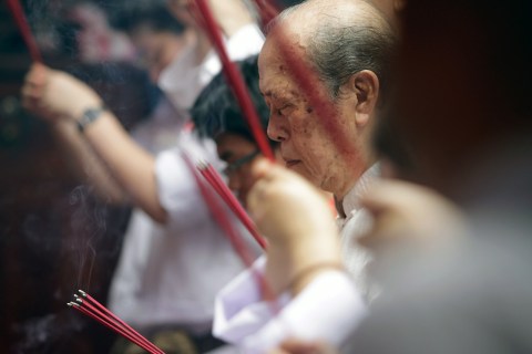 Ethnic Chinese Indonesians recite prayer during Chap Goh Meh celebrations at a temple on February 24, 2013 in Jakarta.
