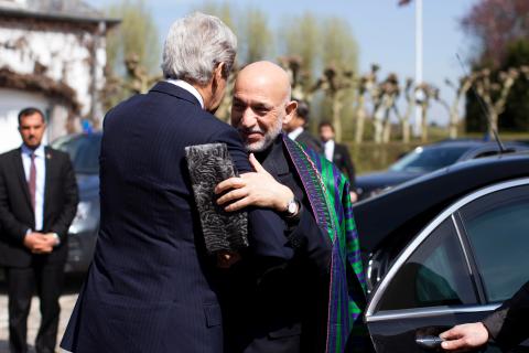 From Left: U.S. Secretary of State John Kerry greets Afghan President Hamid Karzai before a meeting with Pakistani Army Chief General Ashfaq Parvez Kayani (not pictured) in Brussels, on April 24, 2013.