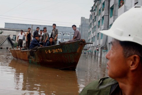 A rescue boat sails through a flooded street in Anju City, South Phyongan Province, North Korea, July 30, 2012.