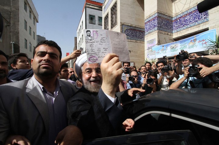 Presidential candidate Hassan Rohani shows his identity papers during the Iranian presidential election in Tehran