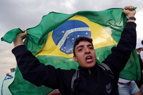 A demonstrator with the Brazilian flag protests against the Confederation's Cup and the government of Brazil's President Dilma Rousseff in Brasilia, on June 17, 2013.