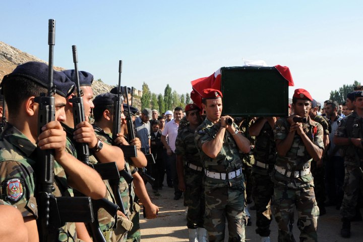 Lebanese army soldiers carry the coffin of Corporal Abdul Karim Kabalan Teimy during his funeral in Al-Faaour , near Zahle town in the Bekaa Valley