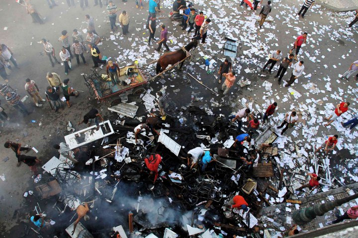 A scene of the aftermath of a fire that was set in the headquarters of the Freedom and Justice Party by anti-Mursi protesters during clashes between them and supporters of Egyptian president Mohamed Mursi in Sedy Gaber in Alexandria, June 28, 2013. 