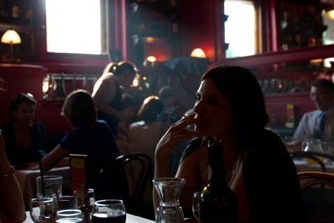 A woman smokes a cigarette in a cafe in Moscow, on May 31, 2013. 