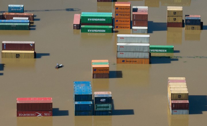 Shipping containers are partly immersed in water at the flooded harbour in Riesa after Elbe river has broken its banks