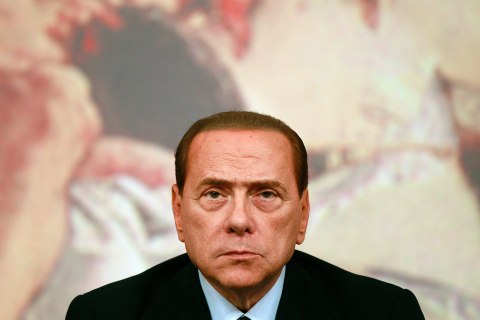 Then Italian Prime Minister Silvio Berlusconi looks on during a news conference at Chigi Palace in Rome August 4, 2011. 