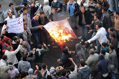 Egyptian protesters burn the Qatari flag in Tahrir Square in Cairo, on Jan. 27, 2013.