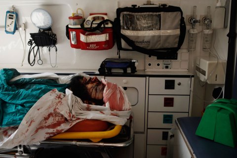 The body of an Egyptian man lies in an ambulance after a clash between pro-Morsi protestors and Egyptian military at the Republican Guard headquarters in Cairo, on July 8, 2013.