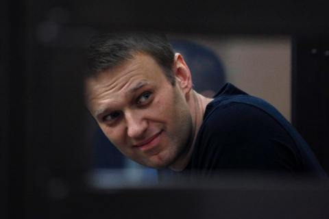 Russian protest leader Alexei Navalny looks out from a glass-walled cage during a court session in Kirov, July 19, 2013.