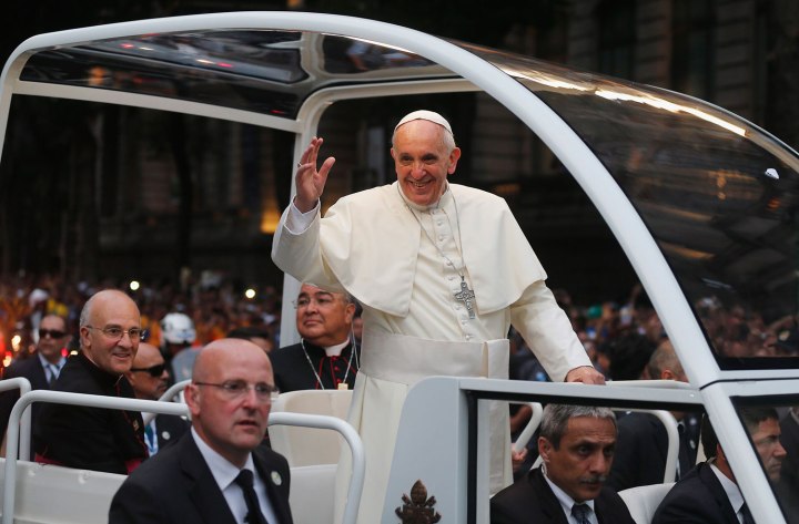 Pope Francis greets crowd of faithful from his popemobile in downtown Rio de Janeiro