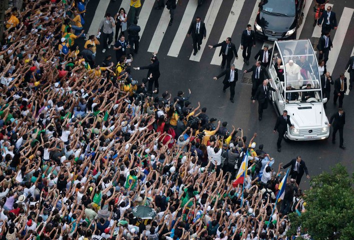 Pope Francis greets crowd of faithful from popemobile in downtown Rio de Janeiro