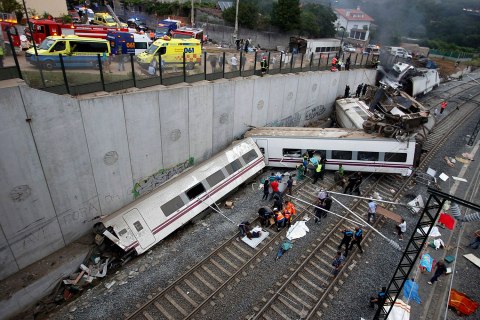 Rescue workers pull victims from a train crash near Santiago de Compostela