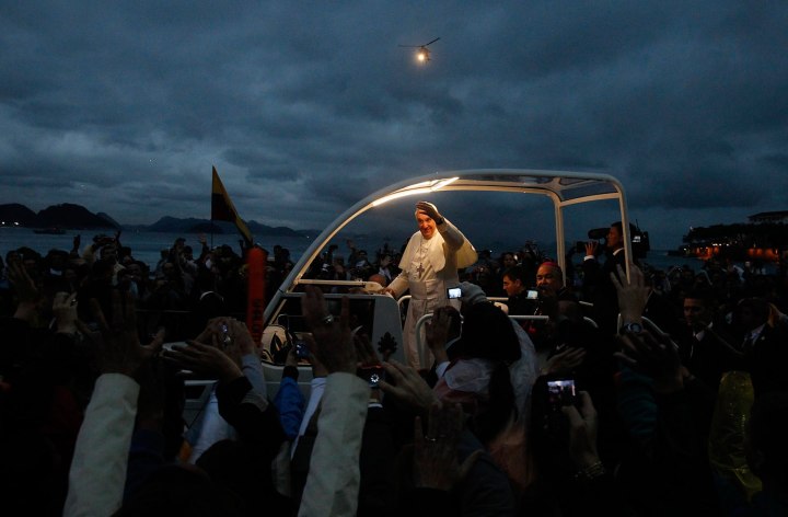 Pope Francis greets Catholic pilgrims during his arrival at Copacabana beach in Rio de Janeiro
