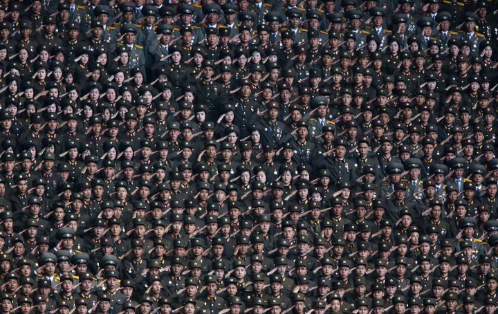 North Korean soldiers salute as their leader Kim Jong-un arrives in Pyongyang