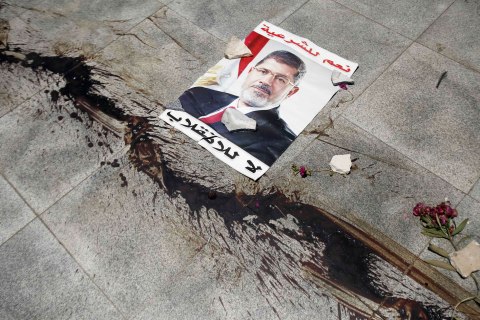 The blood from members of Muslim Brotherhood and supporters of deposed President Mursi, killed during late night clashes, stain floor near a poster of Mursi at Tomb of the Unknown Soldier in Nasr city