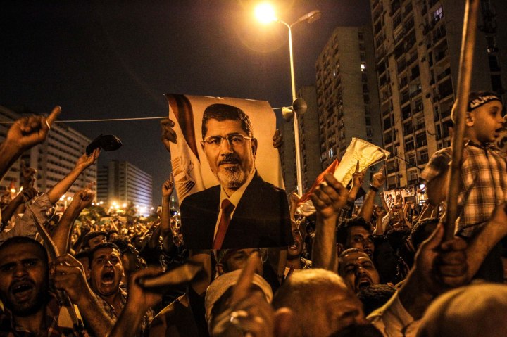 Supporters of Mohamed Morsi shout slogans near Raba'a Al-Adaweya Square in Nasr city, Cairo, on July 7, 2013.