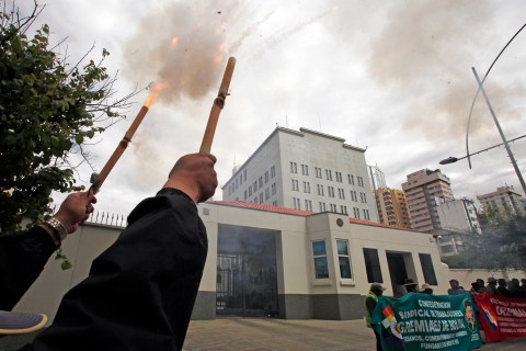 Demonstrator launch firecrackers outside the U.S. embassy to protest the denial of permission for Bolivia's President Evo Morales to enter the airspace of some European countries, in La Paz, Bolivia, on July 8, 2013.