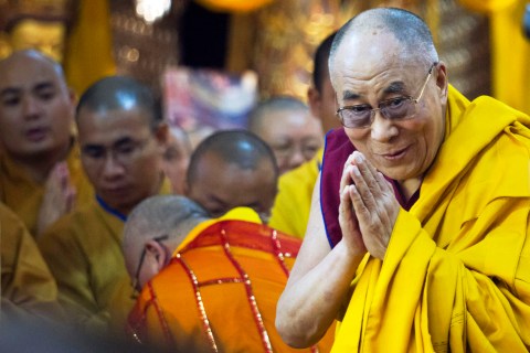The Dalai Lama greets devotees as he arrives to give a religious talk at the Tsuglakhang temple in Dharmsala, India, on  July 01, 2013.
