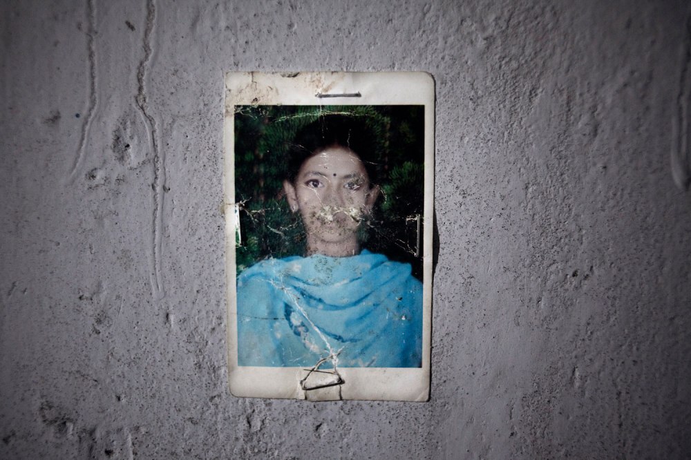 After Shanta's father died, she became her family's sole breadwinner, supporting her mother and younger brother with her wages from the garment factory. Her mother, Shahida, does not know the name of the factory where she worked and has begun selling their furniture to pay the rent on their home, where Shanta's photo is proudly displayed.