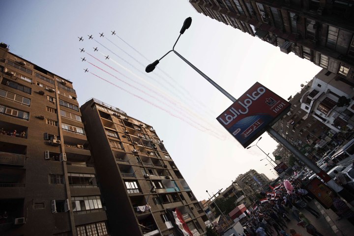 Egyptian Air force acrobatic jets fly above protesters marching towards Egypt's landmark Tahrir square against deposed President Mohammed Morsi on July 7, 2013 in Cairo, Egypt. 
