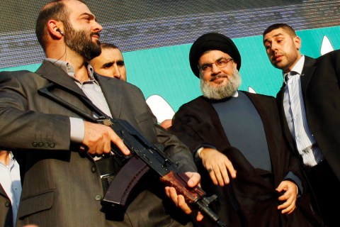 Center: Hezbollah leader Sayyed Hassan Nasrallah, escorted by his bodyguards, greets his supporters at an anti-U.S. protest in Beirut's southern suburbs, on Sep. 17, 2012