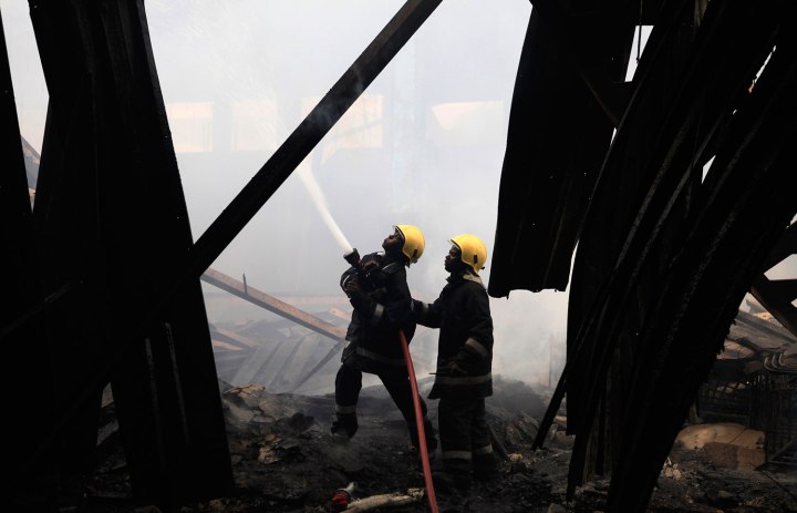 Fire fighters struggle to put out a fire at the Jomo Kenyatta International Airport in Kenya's capital Nairobi