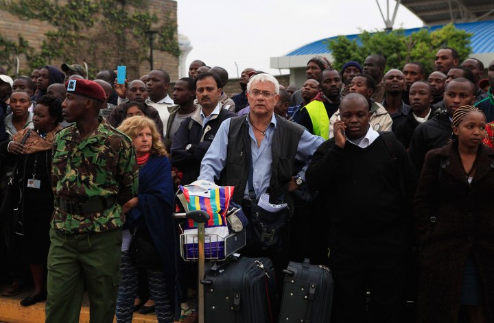 Stranded passengers and onlookers crowd together after fire disrupted all operations at Jomo Kenyatta International Airport in Nairobi