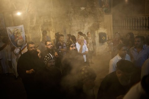 Coptics Priests and Monks purify with incense the holy cave during a procession within Al-Mahraq monastery in Assiut, Upper Egypt, Aug. 6, 2013. 