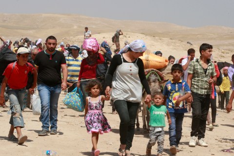 Syrian refugees cross into Iraq at the Peshkhabour border point in Dahuk, Iraq, on Aug. 20, 2013.