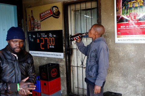 Men drink beer at a bar in Soweto, southwest of Johannesburg, on Aug. 8, 2012. 