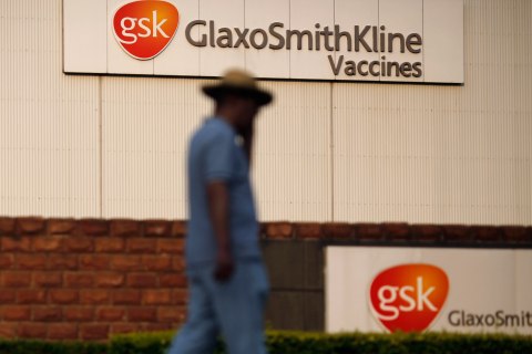 A man walks in front of a A GlaxoSmithKline factory at Pudong district in Shanghai