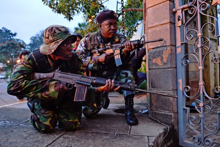 Kenyan soldiers take cover after heavy gunfire near Westgate mall in Nairobi on Sept. 23, 2013.