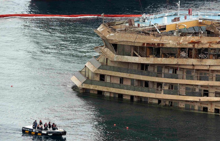 The damaged side of the capsized cruise liner Costa Concordia is seen at the end of the "parbuckling" operation outside Giglio harbour