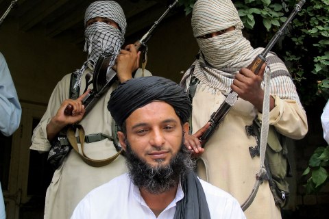 Asmatullah Muawiya, head of the Taliban’s faction of fighters from central Punjab province, listens to reporters at an undisclosed place in Pakistani tribal region of Waziristan, Aug. 15, 2013. 