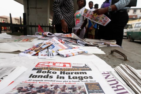 Newspapers are displayed at a stand along a road in Obalende district in Lagos