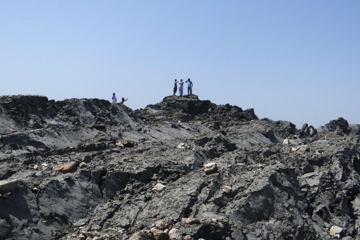 In this photo released by the Pakistani Government, Pakistani men walk on an island that appeared 2 kilometres off the coastline of Gwadar on Sept. 25, 2013, after an earthquake the day before. 