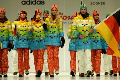 From right: German freeskier Benedikt Mayr and speed skater Monique Angermueller hold the German flag as they present the official German Olympic team's outfit for the 2014 Olympic winter games, in Duesseldorf, on Oct. 1, 2013.