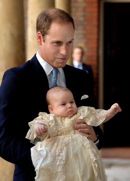 Prince William, Duke of Cambridge arrives, holding his son Prince George, at Chapel Royal in St James's Palace, ahead of the christening of the three month-old Prince George of Cambridge by the Archbishop of Canterbury on October 23, 2013 in London.