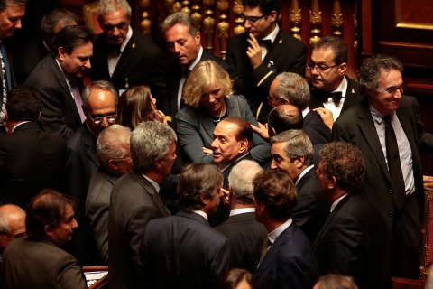Italian center-right leader Berlusconi leaves during confidence vote at Senate in Rome
