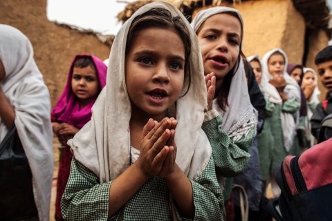 Girls pray before starting classes at a school in Islamabad, on Oct. 11, 2013.