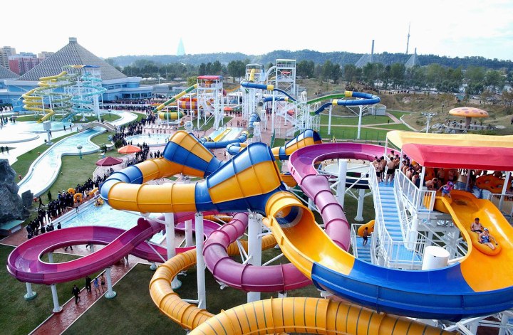 Spectators watch people use The Munsu Water Park in Pyongyang in this undated photo released by North Korea's KCNA