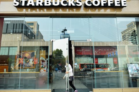 A customer enters a Starbucks Coffee in Hangzhou, China, on Oct. 21, 2013.