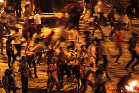 Protesters throw stones during a clash between supporters and opponents of ousted Egyptian President Mursi, at Ramsis square in Cairo