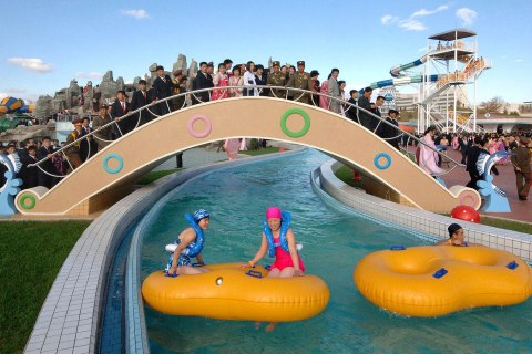 Spectators watch people use The Munsu Water Park in Pyongyang in this undated photo released by North Korea's KCNA