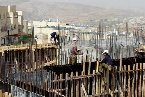 Palestinian labourers work on a construction site in Ramat Shlomo, a religious Jewish settlement in an area of the occupied West Bank Israel annexed to Jerusalem