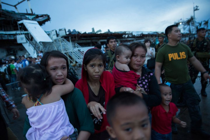 Survivors of Typhoon Haiyan react after not being allowed to board an evacuation flight from Tacloban Airport in Tacloban, Philippines, November 12, 2013.