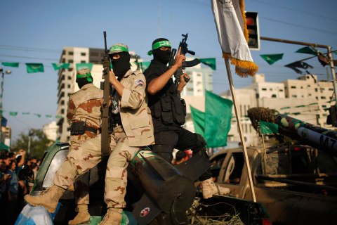 Palestinian Hamas militants take part in a military parade marking the first anniversary of the eight-day conflict with Israel in Gaza