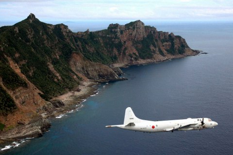 Japan Maritime Self-Defense Force's PC3 surveillance plane flies around the disputed islands in the East China Sea, known as the Senkaku isles in Japan and Diaoyu in China, October 13, 2011.