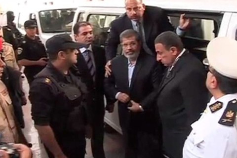 Video still shows ousted former Egyptian President Mursi getting out of a van as he arrives on the first day of his trial, at a courthouse in Cairo