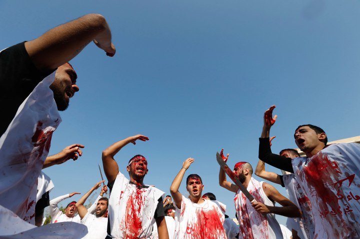 Lebanese supporters of the Shi'ite Amal movement men bleed as they gash their foreheads with swords and beat themselves during a Muharram procession to mark Ashura in Beirut